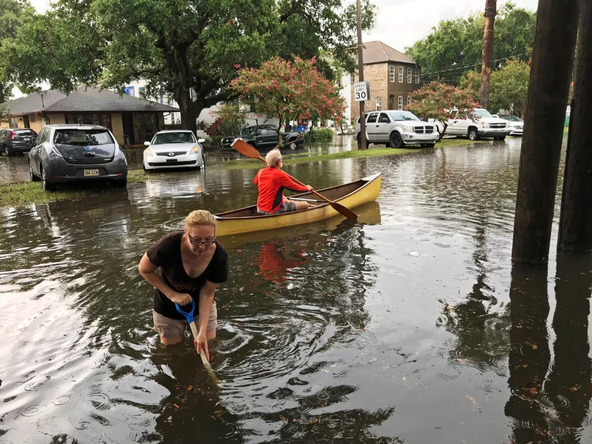 People cope with the aftermath of severe weather in the Broadmoor neighbourhood in New Orleans, Wednesday, July 10, 2019. (Nick Reimann/The Advocate via AP)