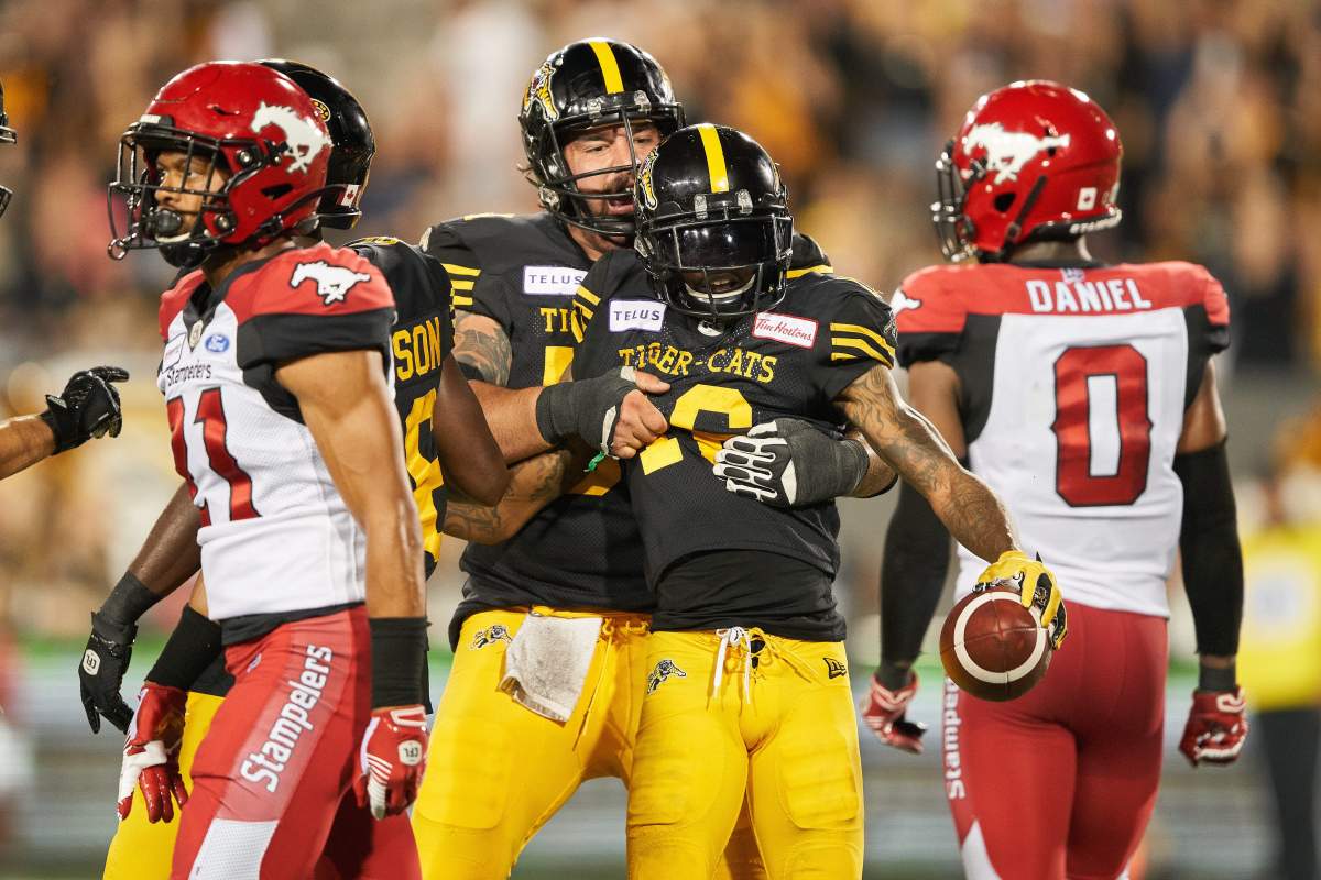 HamiltonÄôs Brandon Banks celebrates his touchdown with Mike Filer during fourth quarter CFL action between the Ticats and the Calgary Stampeders in Hamilton, Ontario on Saturday, July 13, 2019  .
