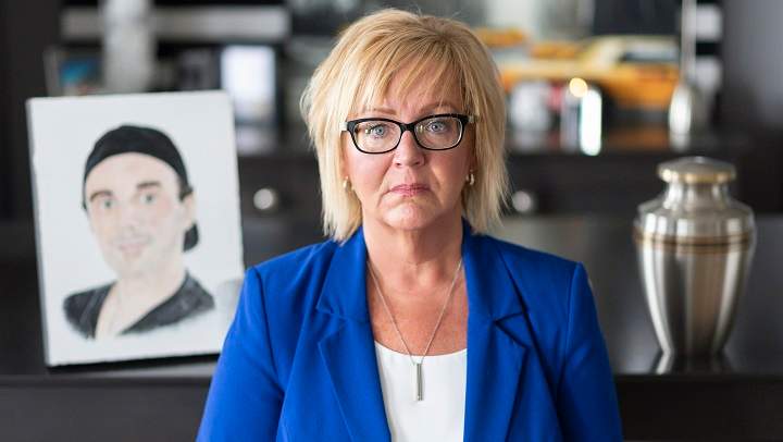 Jenny Churchill poses by a portrait of her son Jordan, who died of a fentanyl overdose in 2018, at her home in Regina on Friday, July 12, 2019.