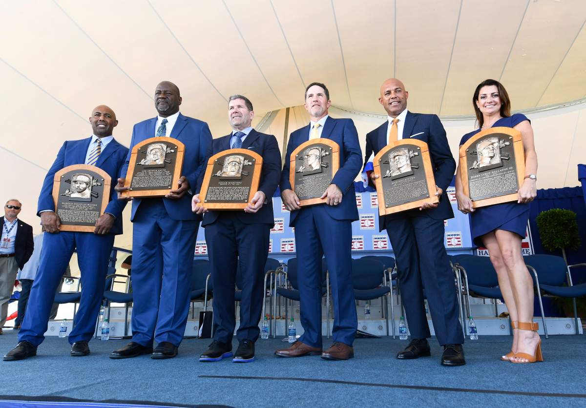 National Baseball Hall of Fame inductees Harold Baines, Lee Smith, Edgar Martinez, Mike Mussina, Mariano Rivera, and Brandy Halladay, widow of the late Roy Halladay, hold their plaques for photos after the induction ceremony at Clark Sports Center on Sunday, July 21, 2019, in Cooperstown, N.Y.