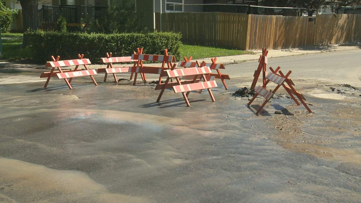 Water pouring into the street from a water main break at 3rd Avenue and Rae Street.