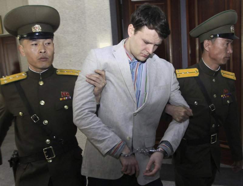 FILE - In this March 16, 2016, file photo, American student Otto Warmbier, center, is escorted at the Supreme Court in Pyongyang, North Korea.