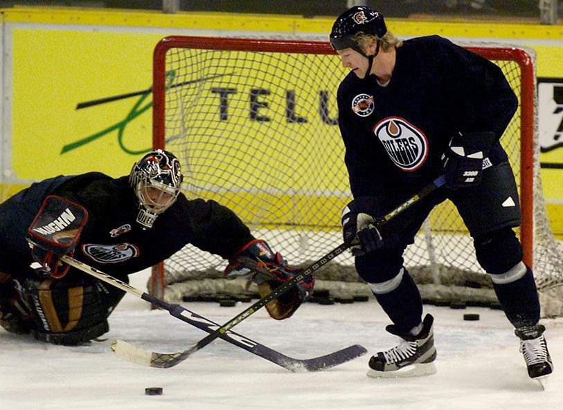 Edmonton Oilers defenceman Marty McSorley gets the better of goalie Bob Essensa during an optional practice in Edmonton Monday, April 26, 1999.  