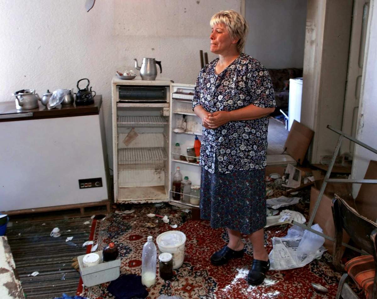 Feride Aliu weeps as she surveys the destruction in her house in Urosevec, Kosovo on Monday June 14, 1999 after returning from being a refugee in Macedonia. Serb soldiers ransacked the house before leaving with the arrival of NATO troops.