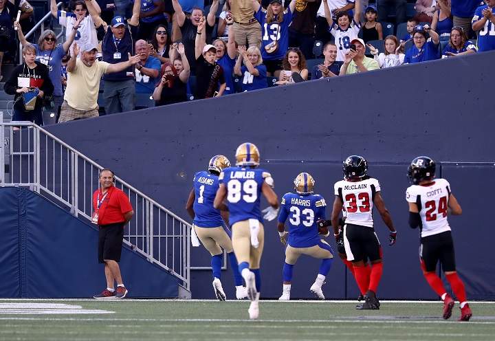 Winnipeg Blue Bombers' Andrew Harris (33) scores a touchdown vs Ottawa Redblacks' during second quarter CFL action in Winnipeg on Friday, July 19, 2019. 