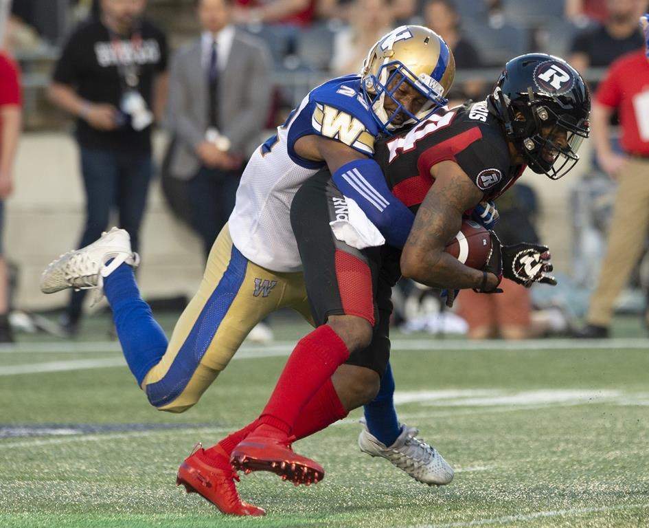 Winnipeg Blue Bombers defensive back Chandler Fenner, left, tackles Ottawa Redblacks wide receiver R.J. Harris during second quarter CFL action in Ottawa, Friday, July 5, 2019. After a disappointing performance against the Winnipeg Blue Bombers last week, the Redblacks are looking for a solid performance this week against the surging Montreal Alouettes and some new faces could play a significant role. THE CANADIAN PRESS/Adrian Wyld.