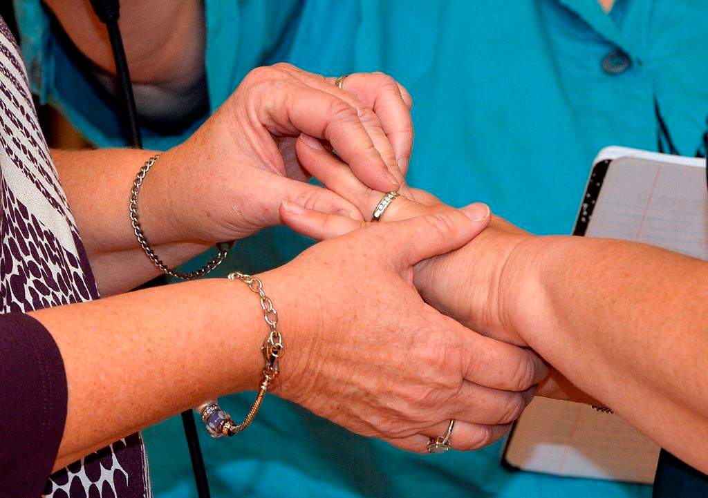Two women place wedding bands on the finger of their partner as they renew their vows in a public ceremony on Oct. 24, 2015, in Morehead, Ky.