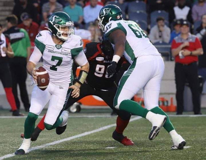 Saskatchewan Roughriders quarterback Cody Fajardo (7) runs with the ball against the Ottawa Redblacks during CFL football action in Ottawa on Thursday, June 20, 2019.