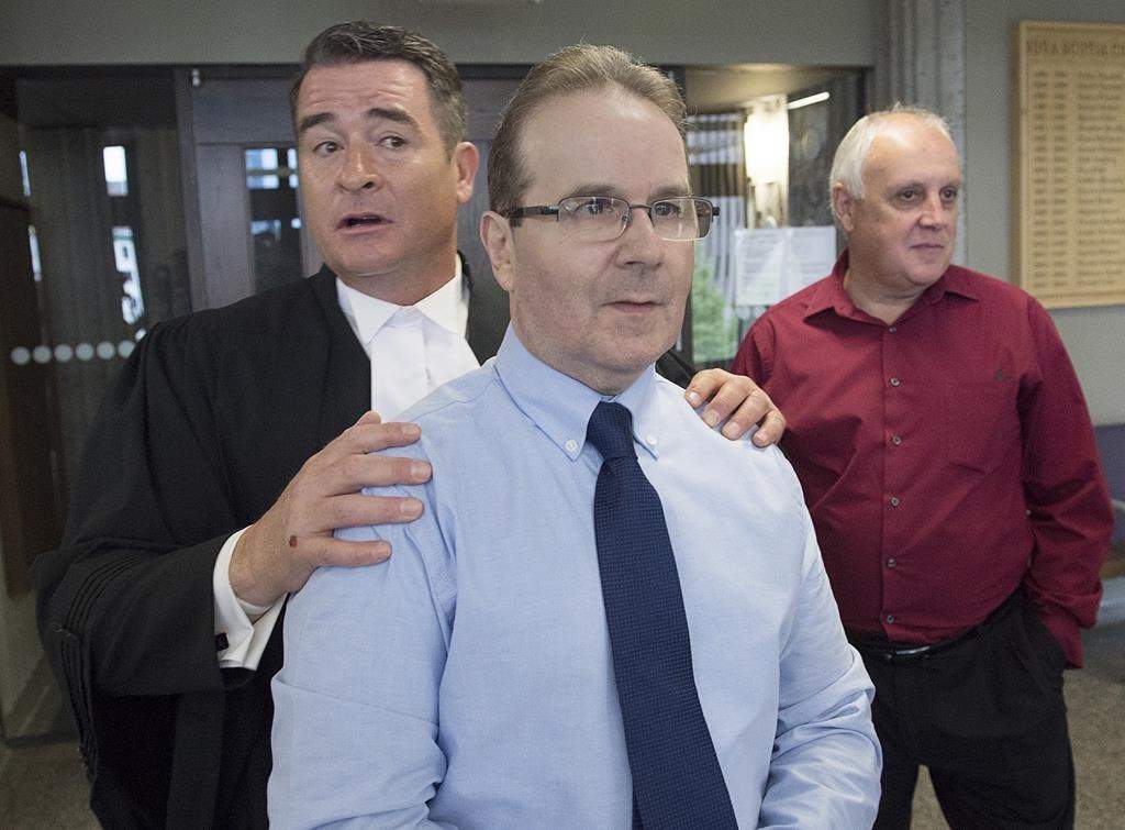 Glen Assoun, the Nova Scotia man who spent almost 17 years in prison for a crime he didn't commit, his lawyer Sean MacDonald and Ron Dalton, right, from the advocacy group Innocence Canada, stand outside Supreme Court in Halifax on Friday, July 12, 2019.