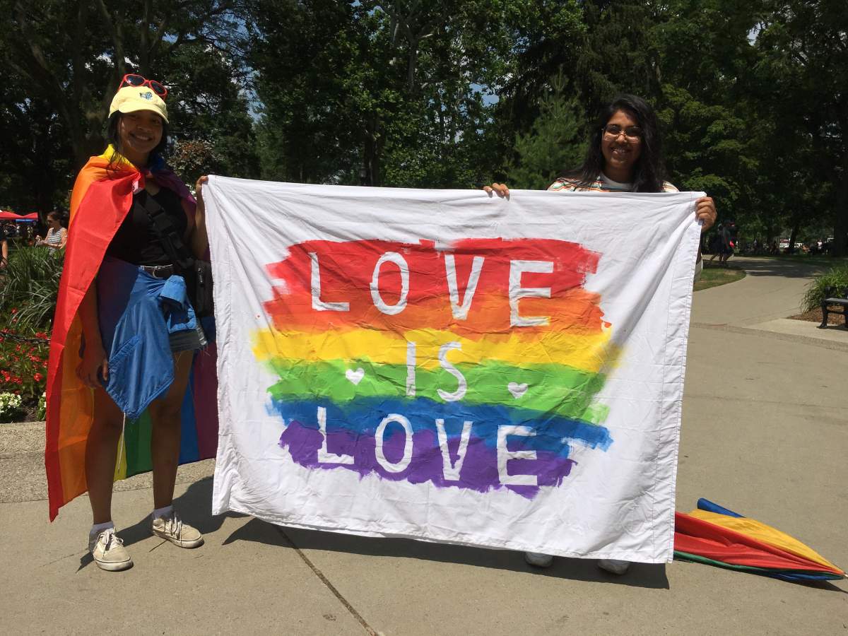 Some participants show off their homemade flag at the 25th Pride Parade.