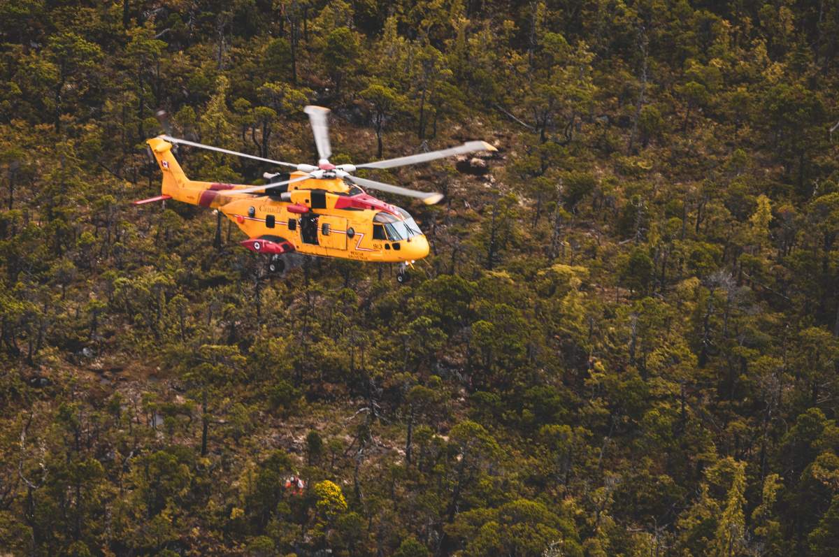 SAR technician being hoisted down from CH-149 Cormorant.