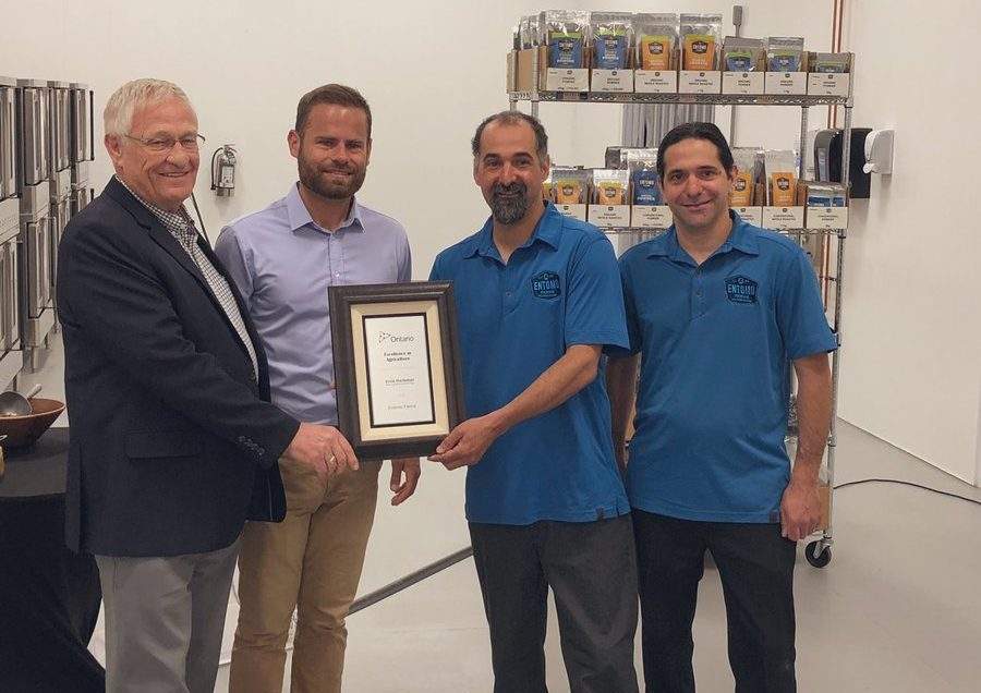 Ontario agriculture minister Ernie Hardeman, left, and MPP David Piccini, present Entomo Farms in Norwood with an Excellence in Agriculture Award on Thursday.