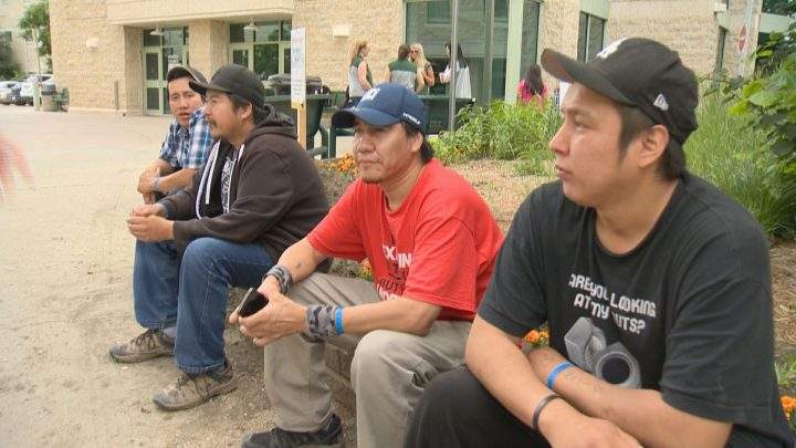 Ontario wildfire evacuees sit outside University of Regina dorm rooms on July 12, 2019. 