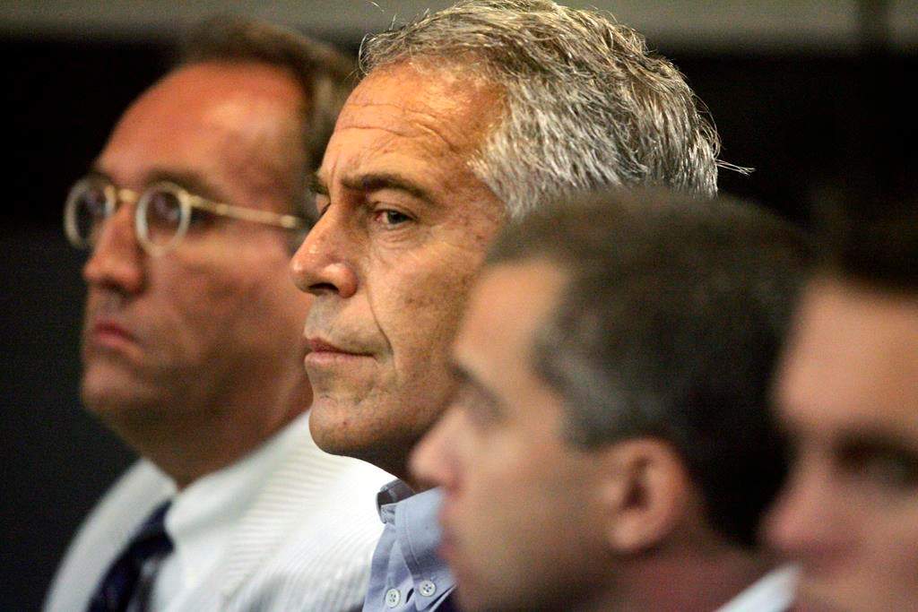 FILE - In this July 30, 2008 file photo, Jeffrey Epstein, center, appears in court in West Palm Beach, Fla. The wealthy financier and convicted sex offender has been arrested in New York on sex trafficking charges. Two law enforcement officials said Epstein was taken into federal custody Saturday, July 6, 2019, on charges involving sex-trafficking allegations that date to the 2000s.