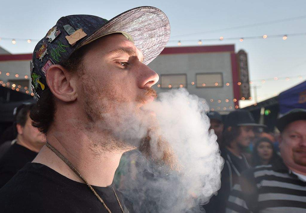 A man smokes a joint at the first annual DOPE Cup, a cannabis competition in Portland, Oregon, in 2015. 