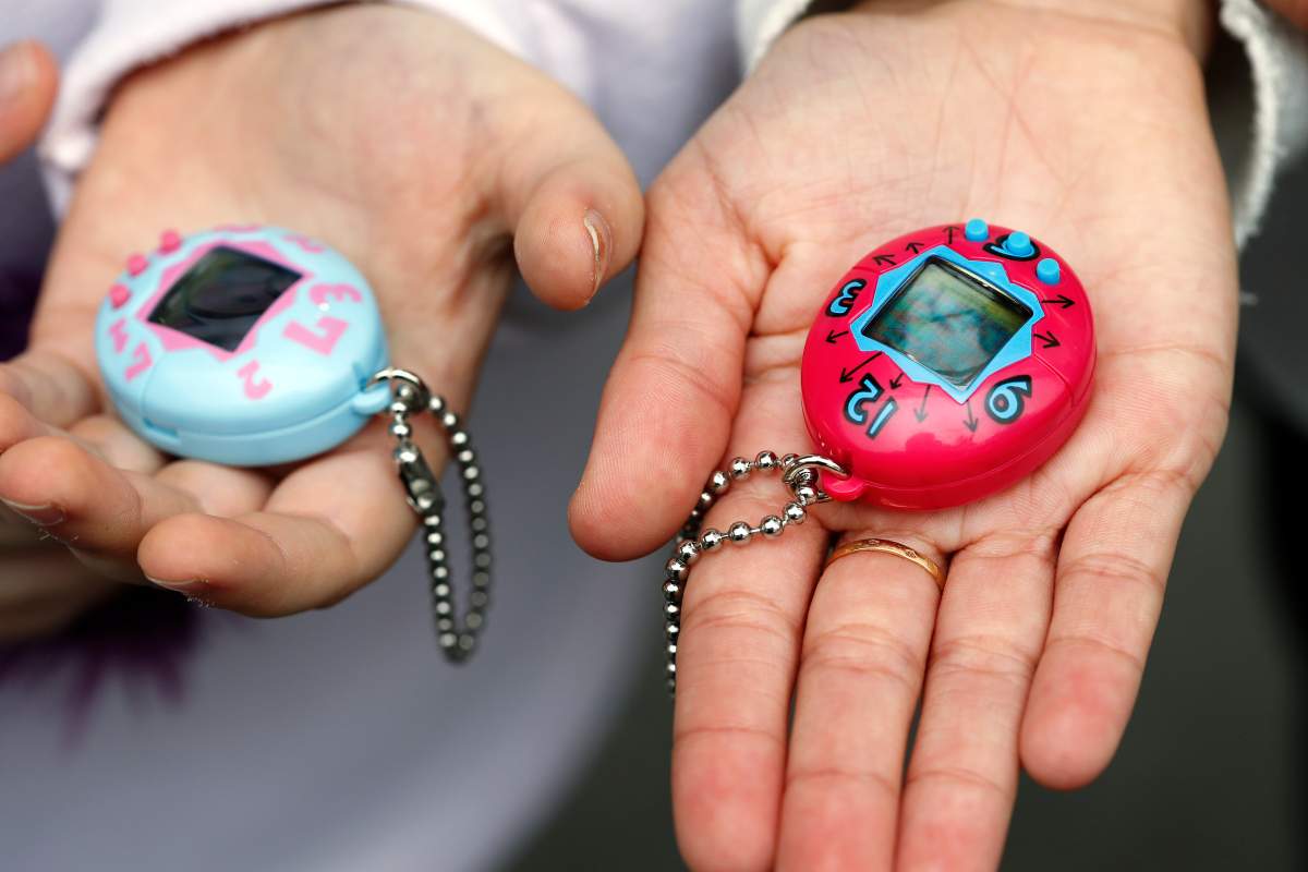 Children show their ‘Tamagotchi’ electronic pet toy on Oct. 25, 2017 in Paris, France. Tamagotchi is a virtual electronic animal which means “cute little egg” and simulates the life of an animal. Twenty years after its creation, the Japanese company Bandai reissues the famous limited edition toy that is available today in France.