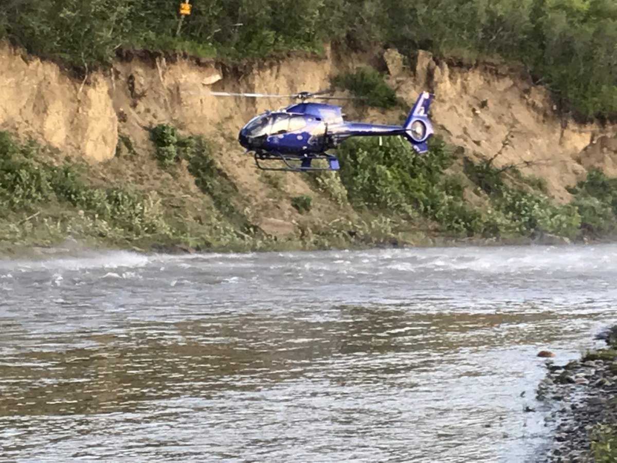 Crews search for a man believed to have fallen in the Highwood River southeast of Calgary, June 30, 2019.
