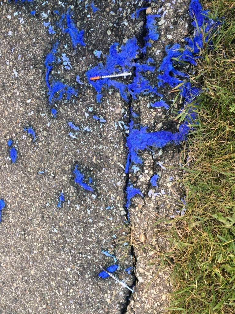 Needles on the pavement.