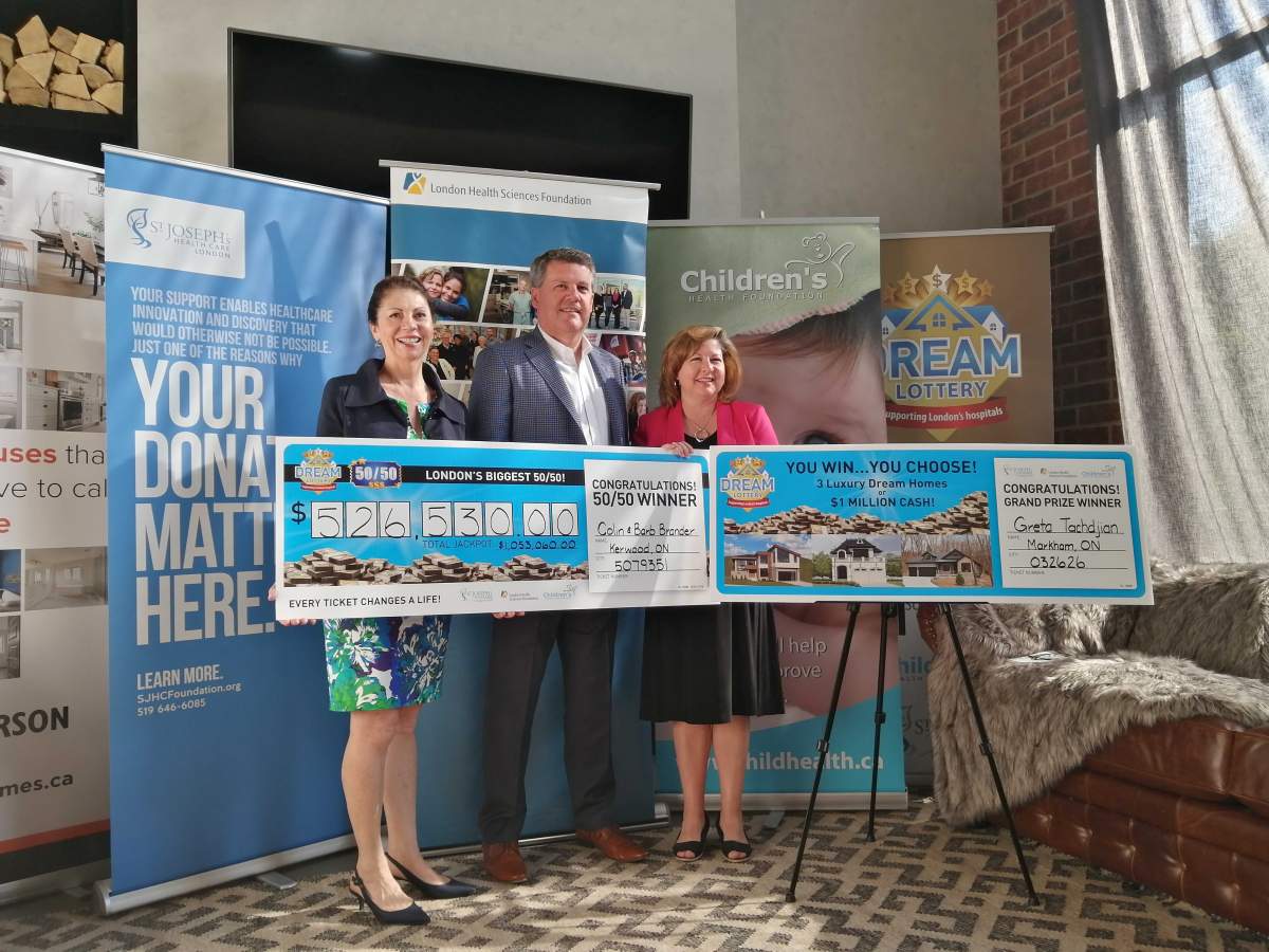 From the left: Elana Johnson, chair of the Children's Health Foundation, John MacFarlane, president and CEO of London Health Sciences Foundation and Michelle Campbell, president and CEO of St. Joseph's Health Care Foundation hold the cheques of the grand prize winner and 50-50 winner at the Jefferson Industrial Dream Home on  Thursday morning.