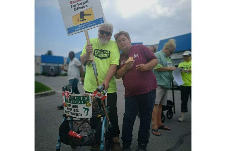David Curtis (pictured left) is protesting the cuts made to Legal Aid Ontario by the provincial government.