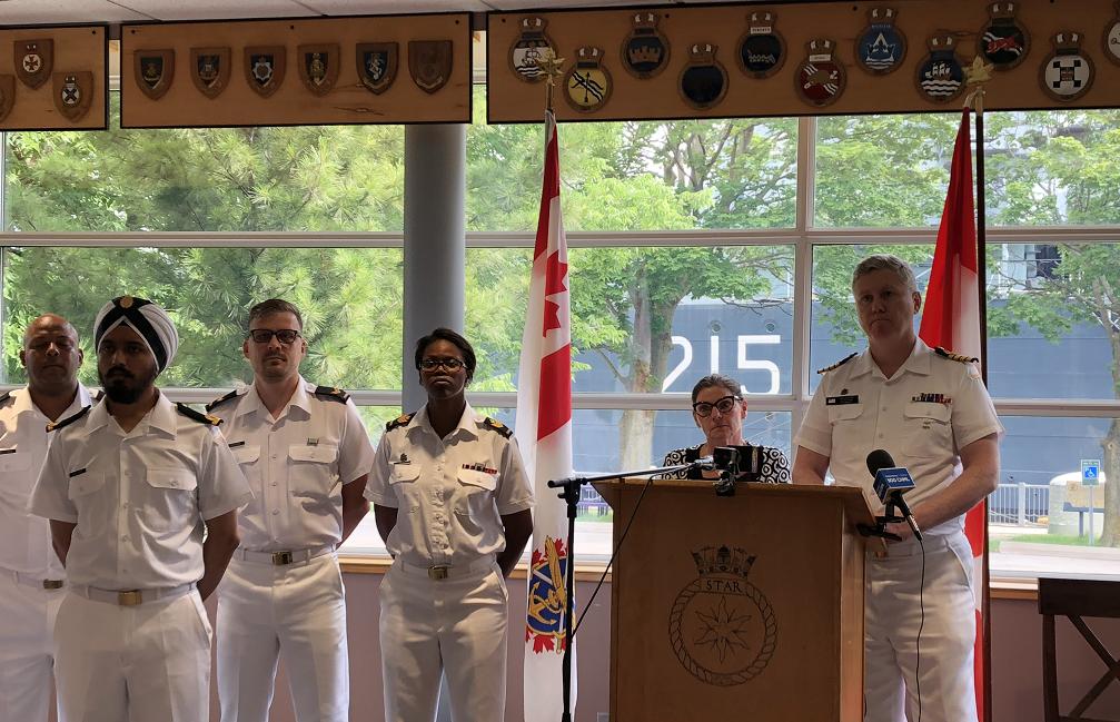 MP Filomena Tassi and Captain Tim O'Leary stand in front of HMCS Haida following Tassi's announcement on behalf of Minister of National Defence Harjit Sajjan.