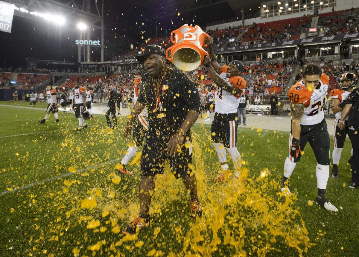 BC Lions wide receiver Alex Charette (11) and linebacker Maleki Harris (31) give head coach DeVone Claybrooks a gatorade shower to celebrate the team's win after CFL football action against the Toronto Argonauts, in Toronto, on Saturday, July 6, 2019. 
