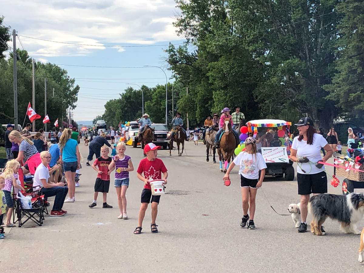 Crowds of children gathering candy at the Magrath Days parade. 