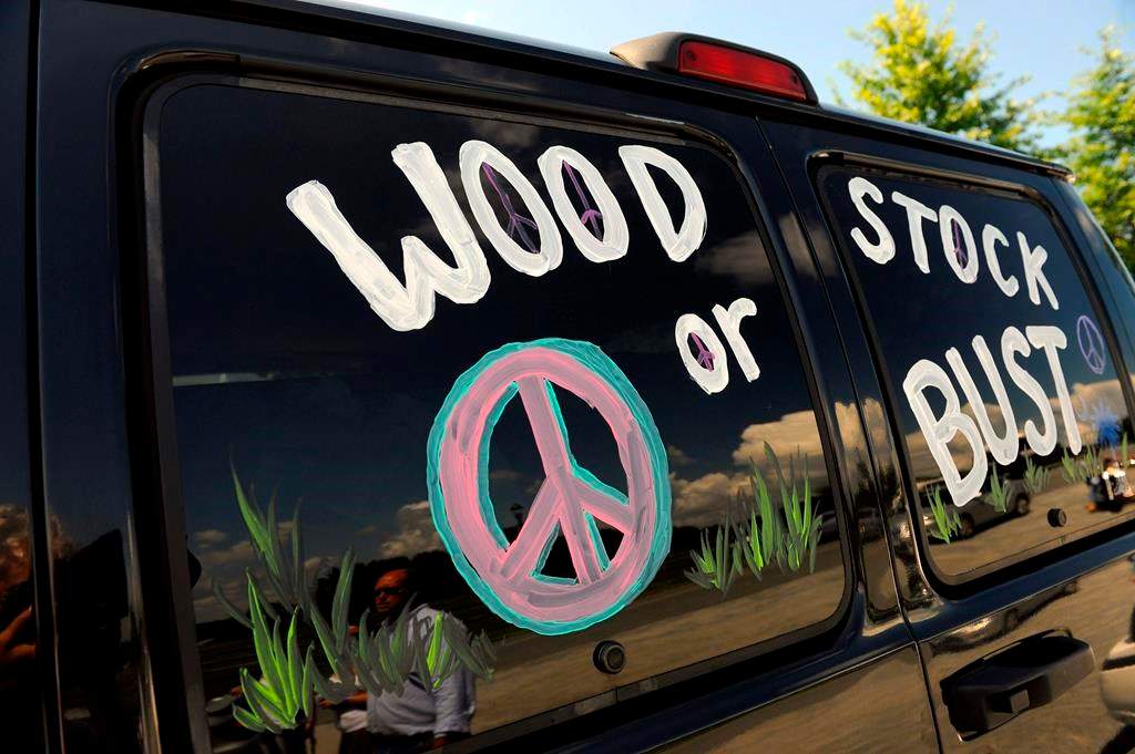 This Aug. 14, 2009 file photo shows a van decorated with “Woodstock or Bust” at the original Woodstock Festival site in Bethel, N.Y. Woodstock 50 is officially cancelled.