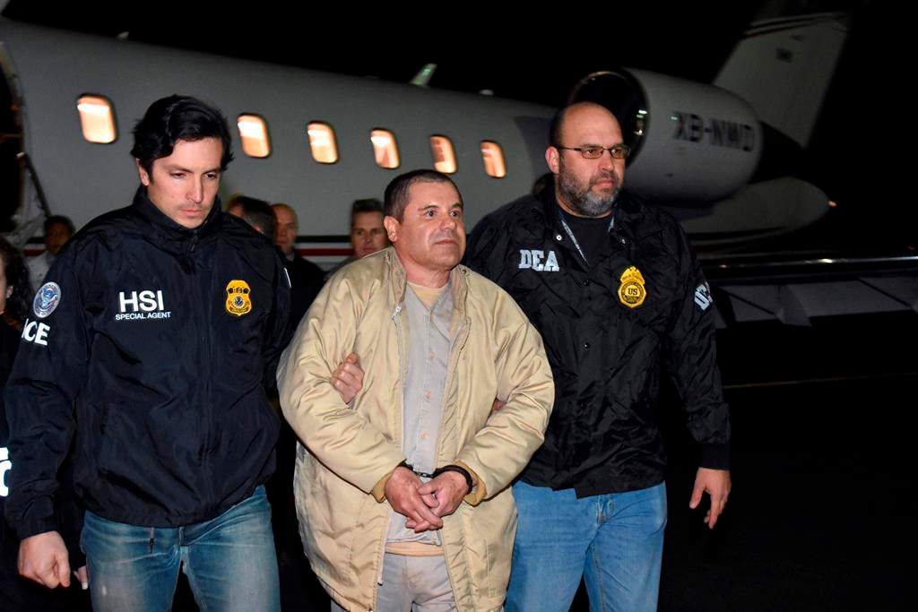 FILE – In this Jan. 19, 2017, file photo provided by U.S. law enforcement, authorities escort Joaquin ‘El Chapo’ Guzman, centre, from a plane to a waiting caravan of SUVs at Long Island MacArthur Airport, in Ronkonkoma, N.Y. Guzman, who was convicted in February 2019 on multiple conspiracy counts in an epic drug trafficking case, will be sentenced in a New York courtroom on Wednesday, July 17, 2019. (U.S. law enforcement via AP, File)