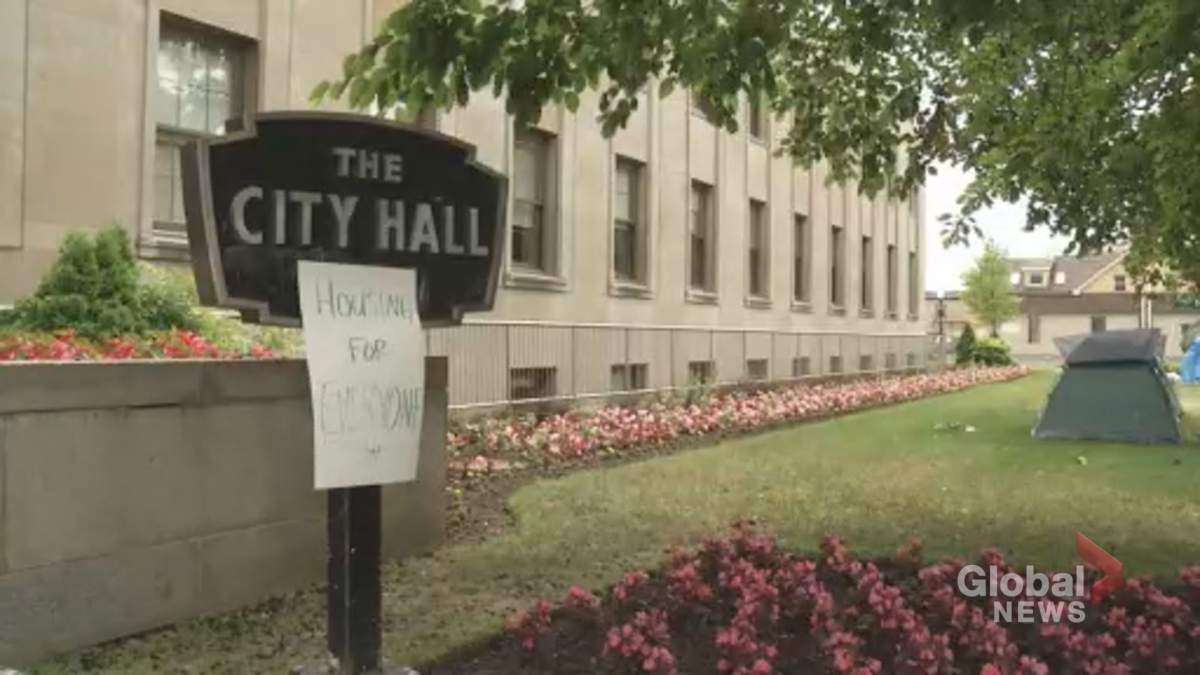 A sign reading "Housing for Everyone" is attached to Peterborough City Hall's signage on Thursday. The mayor says a plan for 2,000 affordable units in two years is underway.