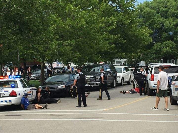 Police and people in handcuffs in downtown Kelowna.