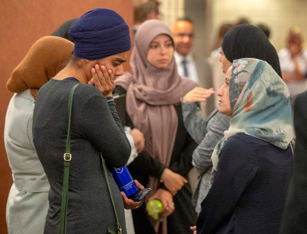 People wait to enter the courtroom for a hearing challenging Bill 21, Quebec's religious symbols law.