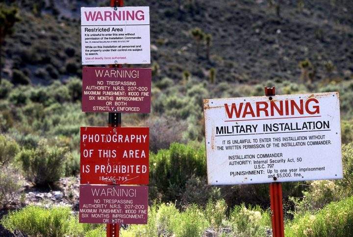 Warning signs at the restricted boundary to Area 51 on an unmarked dirt road near the town of Rachel and the UFO Highway.