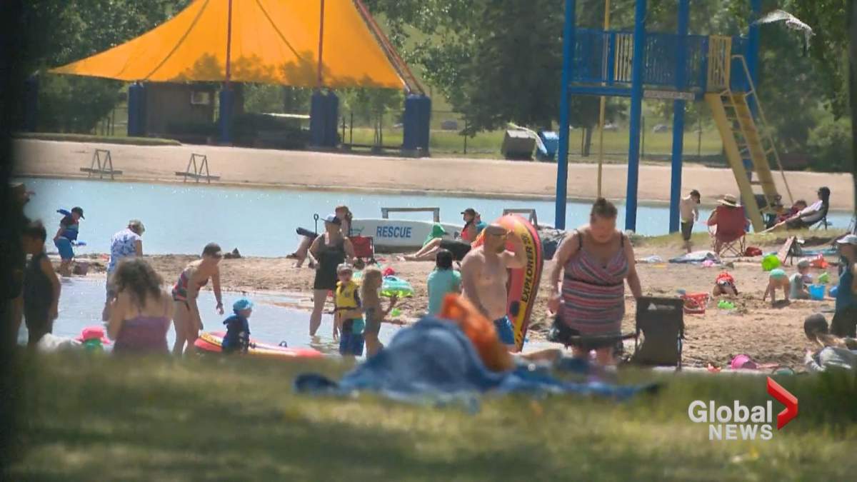 People spending time at Sikome Lake in Calgary on Wednesday, July 31.