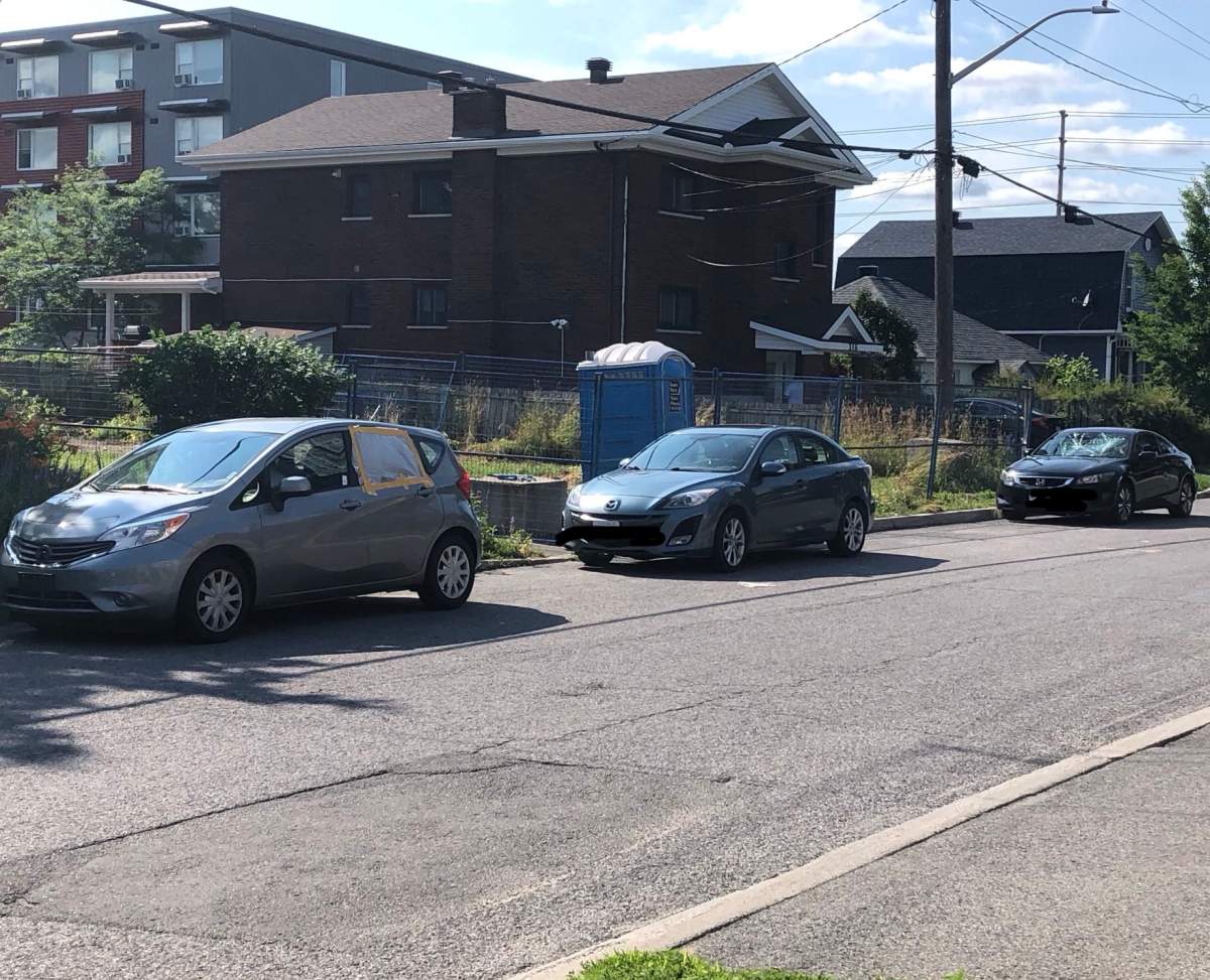 Damaged cars are seen lined up on Tweedsmuir Avenue in Westboro after a vandalism spree over the weekend. Ottawa police are investigating.
