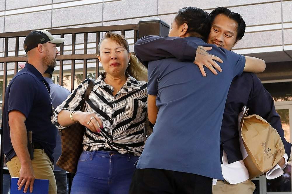 In this Wednesday, June 12, 2019 photo, Ammala Mingsouan embraces family outside the building that houses Immigration and Customs Enforcement and the Atlanta Immigration Court after being released from ICE custody, in Atlanta. Mingsouan's mother Littun Saenbouttaiath, right, said she had not seen him for 24 years. 