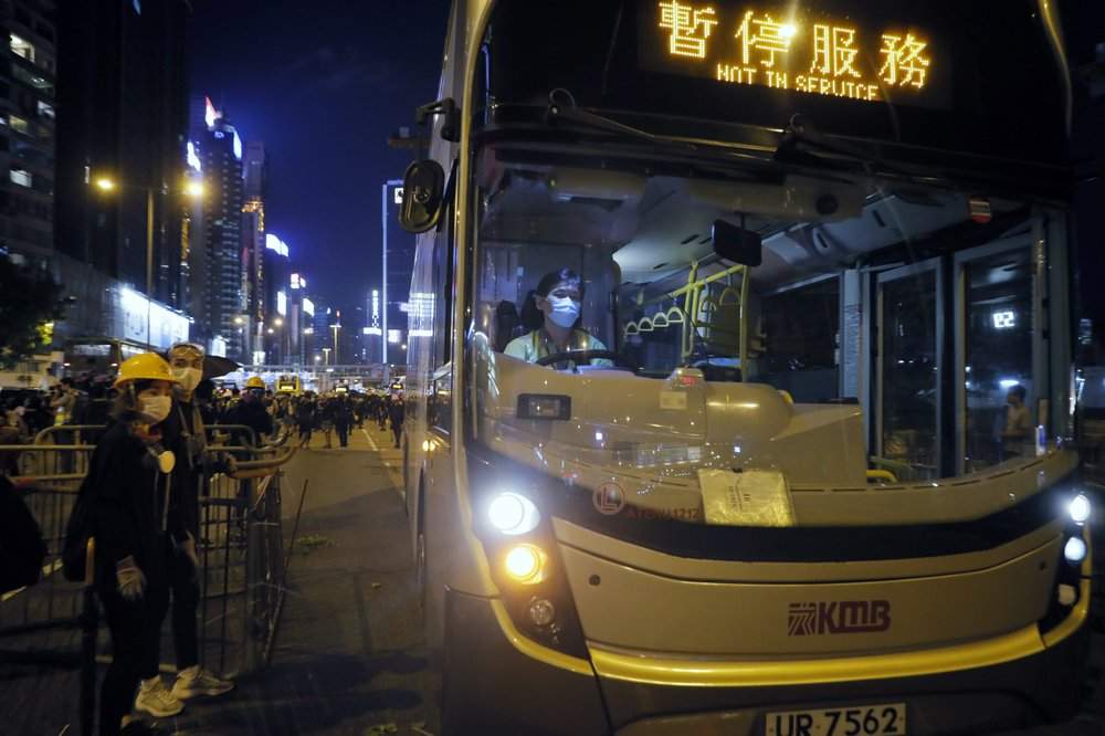 An off duty bus drives pass a barricades by protesters at Causeway Bay to hold the anti-extradition bill protest in Hong Kong, Sunday, Aug. 4, 2019.