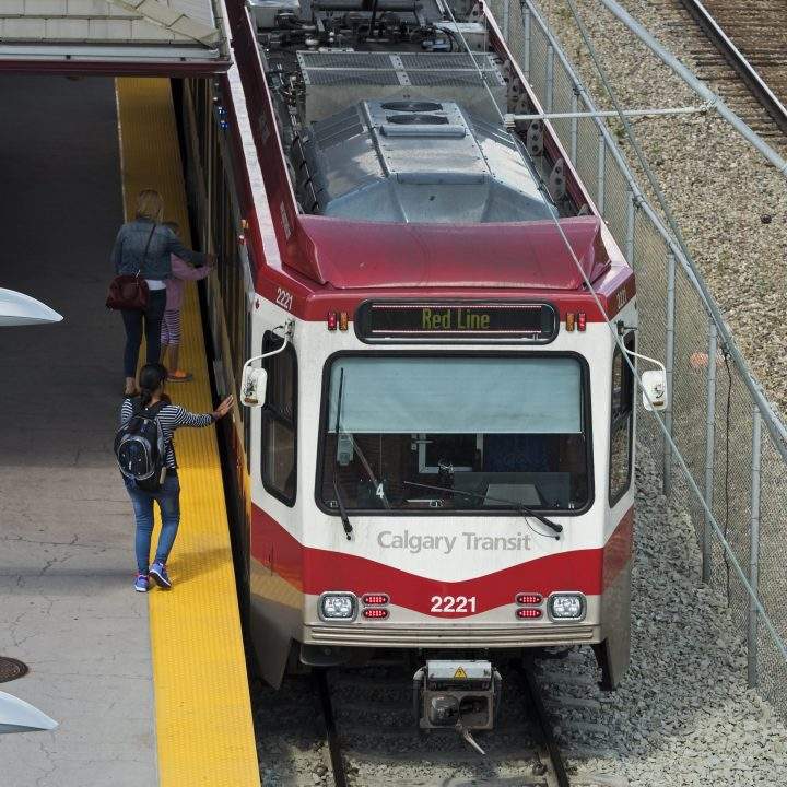 Commuters board a Calgary Transit light rail (LRT) C-Train August 24, 2016.