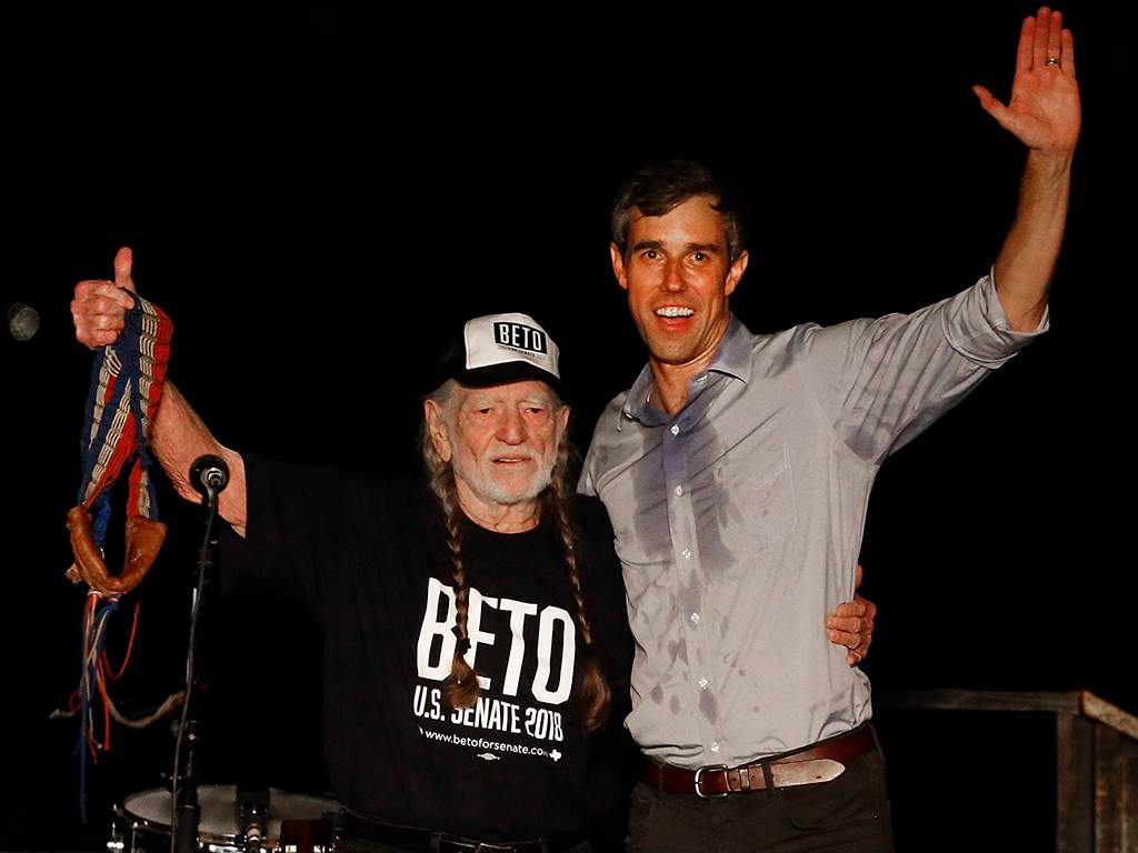 Beto O’Rourke (R) and country music legend Willie Nelson (L) wave to supporters at a Turn Out For Texas Rally in Austin, Texas, on Sept. 29, 2018.