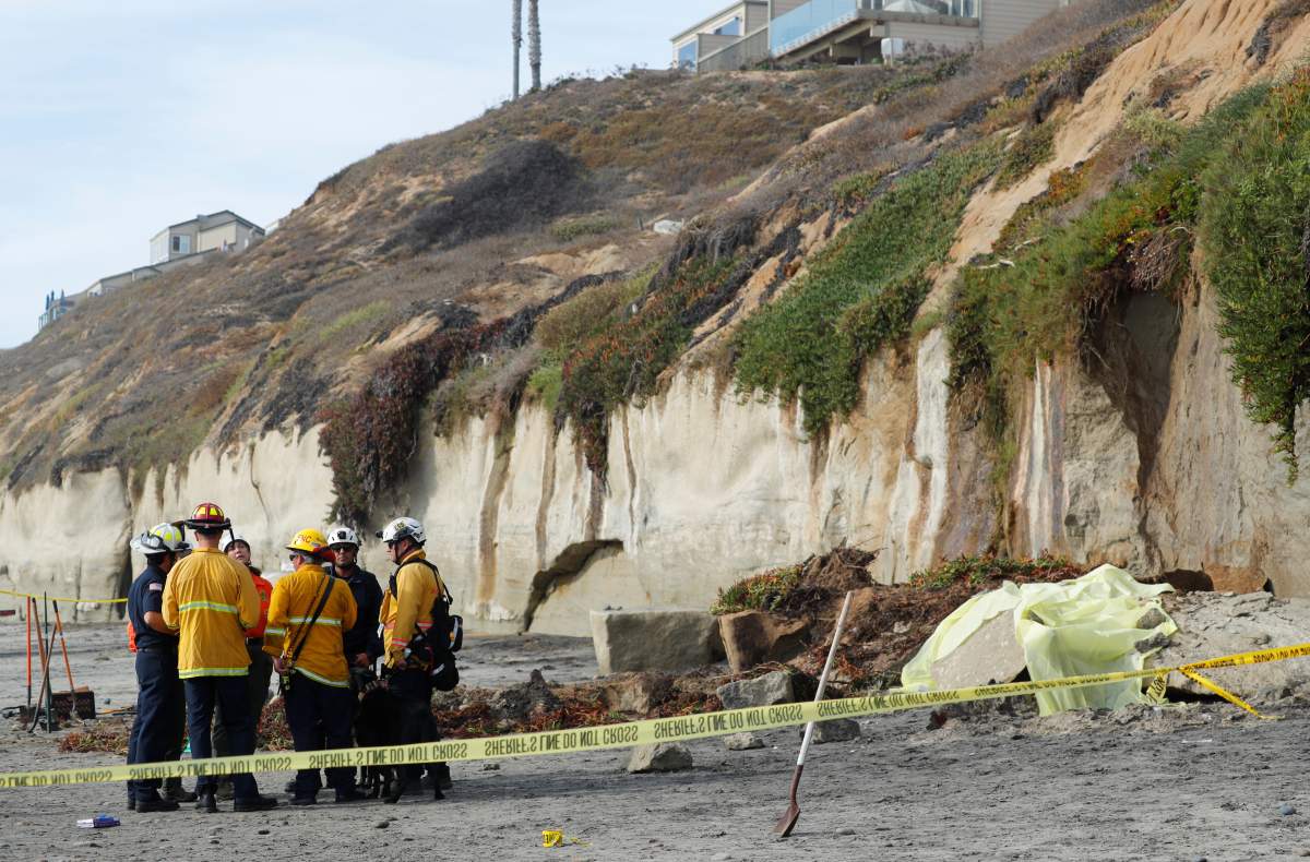 Emergency responders attend to a cliff collapse at a beach in Encinitas, California, U.S., August 2, 2019.