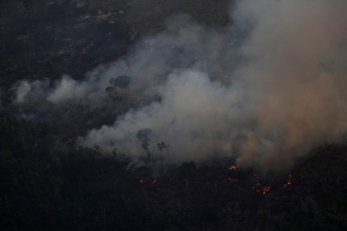 Smoke billows during a fire in an area of the Amazon rainforest near Porto Velho, Rondonia State on Aug. 21.