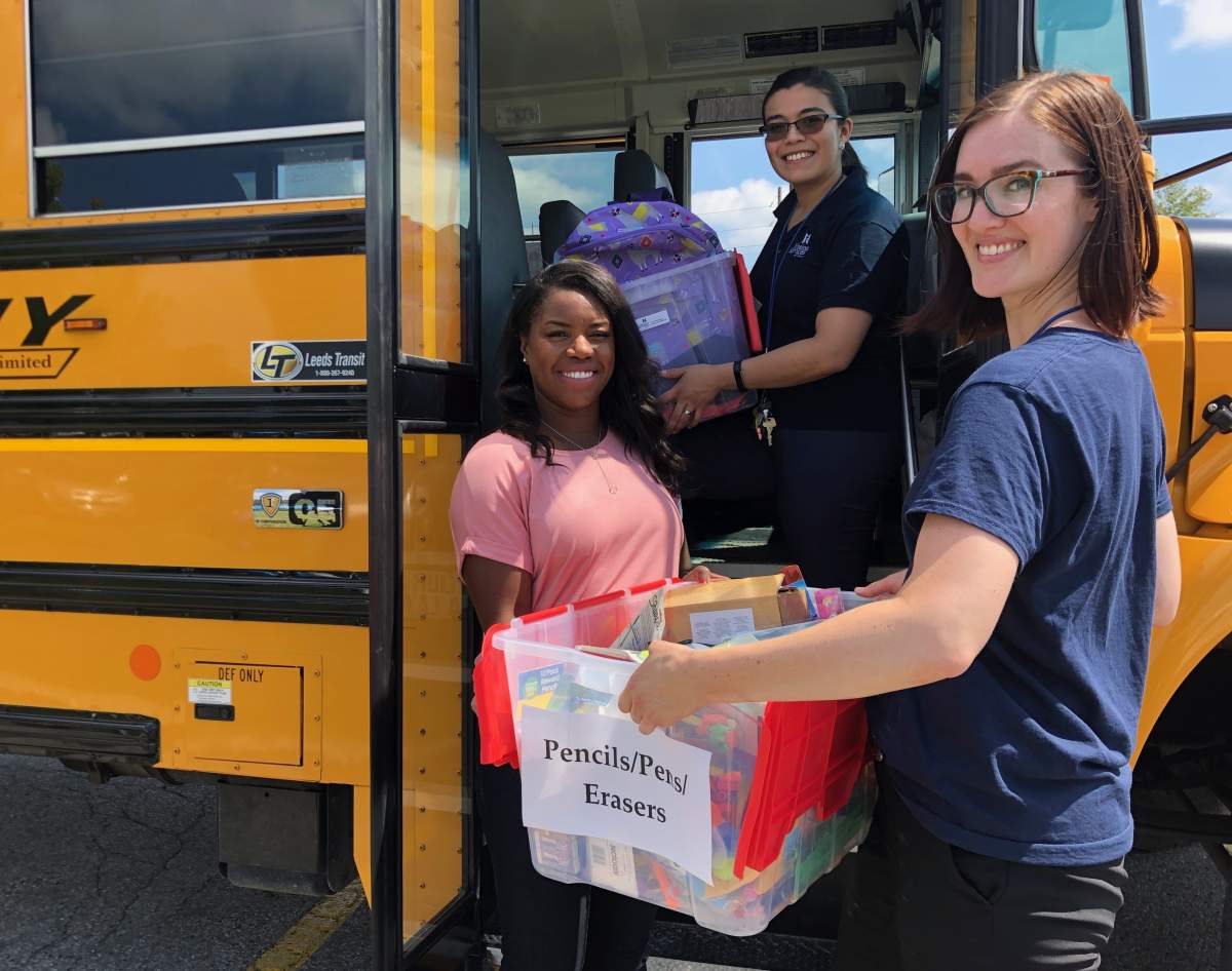 Olympian Perdita Felicien and volunteers load donations during Mission Services of London's "Fill Up the Bus" event.