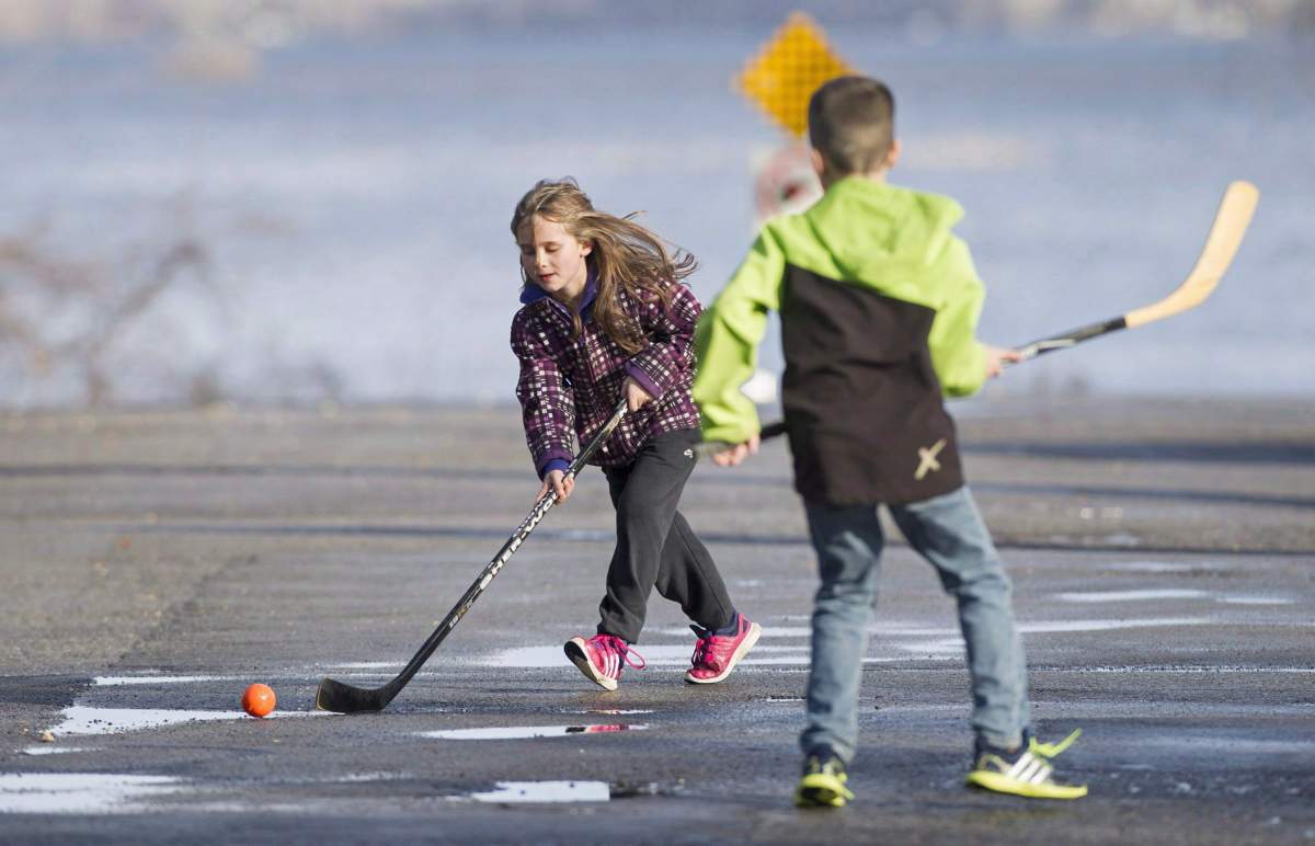 Children play a game of ball hockey in Vaudreuil-Dorion, Que.
