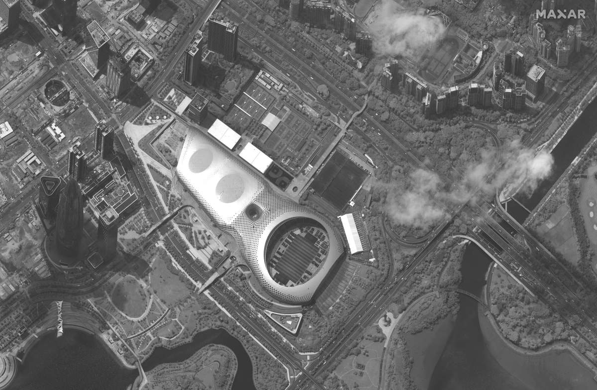 This satellite image captured on Monday, Aug. 12, 2019, provided by Satellite image ©2019 Maxar Technologies appears to show Chinese security force vehicles inside the Shenzen Bay Sports Center, middle, in the southern Chinese city of Shenzhen, bordering Hong Kong.