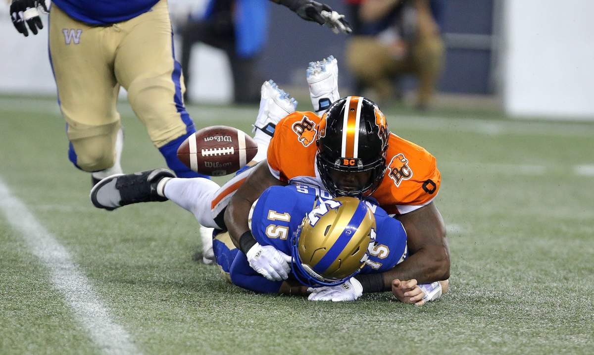 Winnipeg Blue Bombers QB Matt Nichols fumbles while taking a hit from B.C. Lions DL Shawn Lemon during fourth quarter CFL action in Winnipeg on Thursday, August 15, 2019.