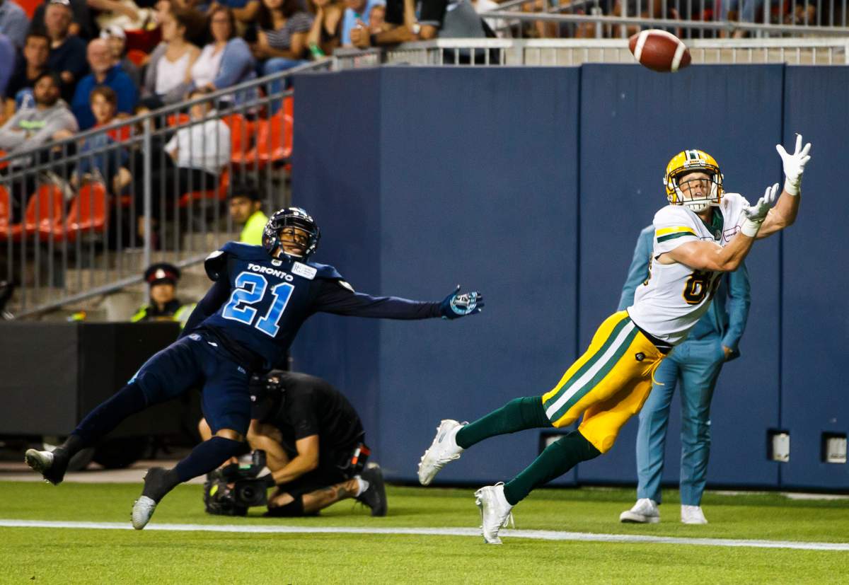 Edmonton Eskimos' Greg Ellingson makes a diving touchdown catch against Toronto Argonauts' Qudarius Ford during the second half of CFL football action in Toronto, Friday August 16, 2019. 
