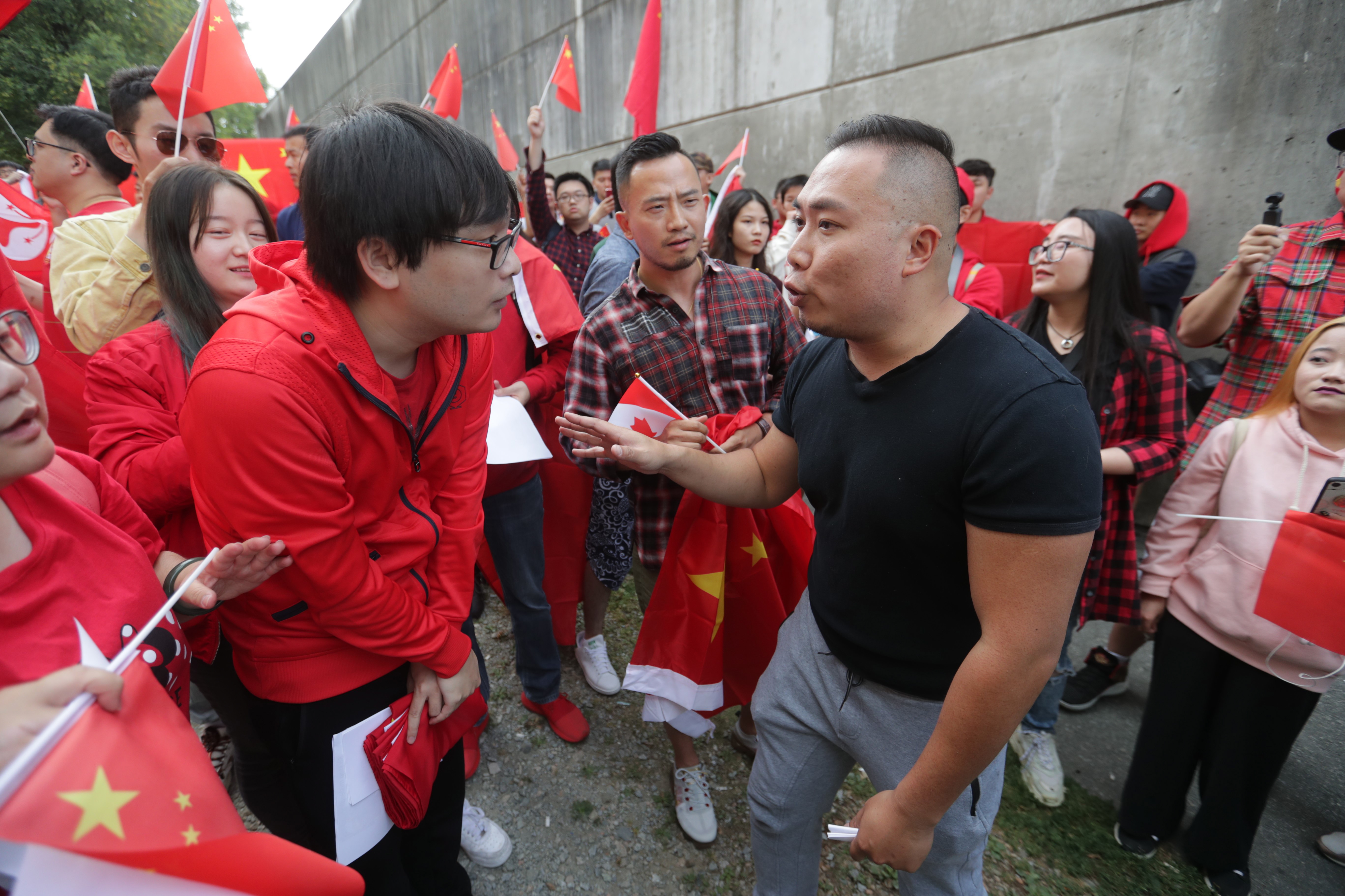 Pro-China counter-protesters, wearing red, shout down a man in a black shirt during an anti-extradition rally for Hong Kong in Vancouver on Saturday August 17, 2019. Violent demonstrations in the former British territory of Hong Kong are now in their 11th weekend. 