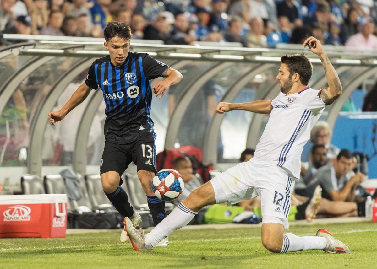 Montreal Impact's Ken Krolicki, left, challenges FC Dallas' Ryan Hollingshead during second half MLS soccer action in Montreal, Saturday, August 17, 2019.
