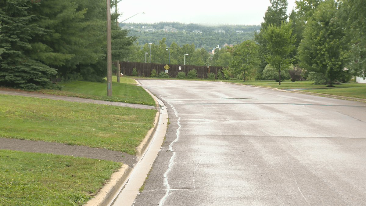 A wooden wall stands at the end of Muirfield/Twin Oaks Drive, separating the neighbourhood from Casino Drive.