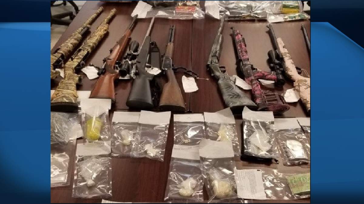 Officers discovered nine firearms, ammunition, bear mace and brass knuckles, as well as quantities of drugs during the search.
